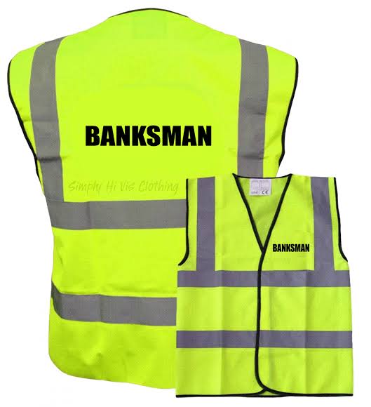 Banksman managing traffic on construction site in Piccadilly Circus - W1